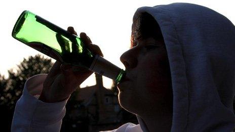 Teenager drinking alcohol from a bottle