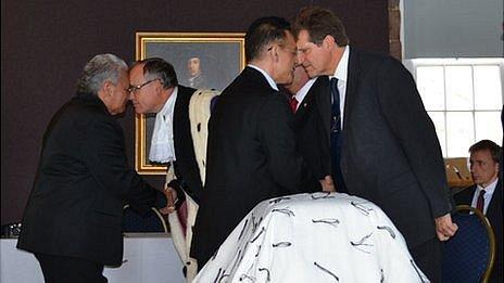 Members of the Guernsey and New Zealand delegations greet each other