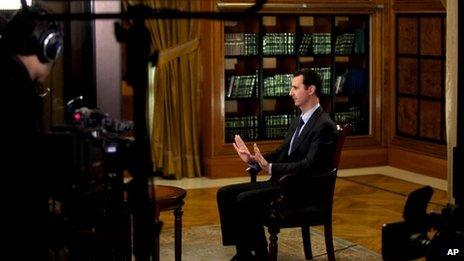 President Bashar Assad gestures as he speaks during an interview with Lebanon's Al-Mayadeen TV