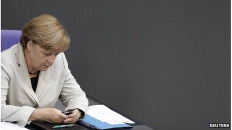 German Chancellor Angela Merkel looks at her mobile in the German parliament, September 2012