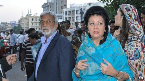 Members of the Vadodara royal family Sangramsingh Gaekwad (left) and wife Asha Raje Gaekwad (second on the right) arrive at a court in Vadodara on 23 October 2013