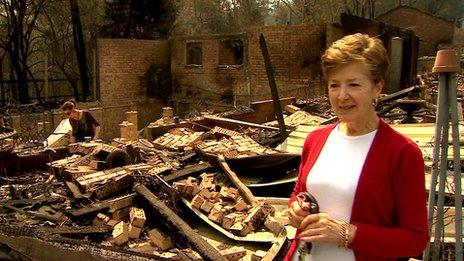 Chris Muller pictured in front of the remains of her house