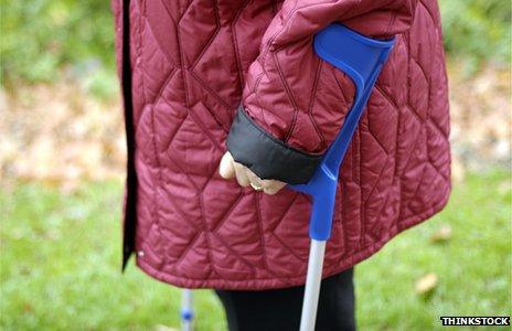 Detail of woman walking with crutches