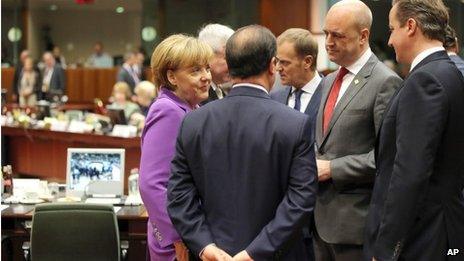 From left clockwise, German Chancellor Angela Merkel, Czech Republic"s Prime Minister Jiri Rusnok, Polish Prime Minister Donald Tusk, Swedish Prime Minister Fredrik Reinfeldt, British Prime Minister David Cameron and French President Francois Hollande speak with each other during a round table meeting at an EU summit in Brussels on Friday