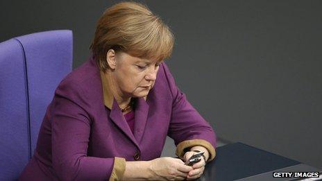 German Chancellor Angela Merkel checks her mobile phone during a session of the Bundestag (30 November 2012)