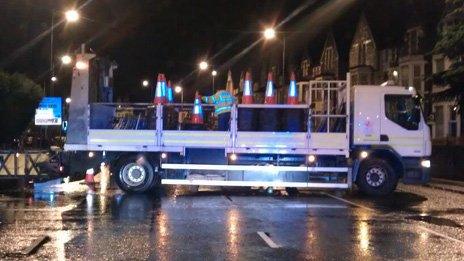 Council workers closing Newport Road in Roath, Cardiff after flooding