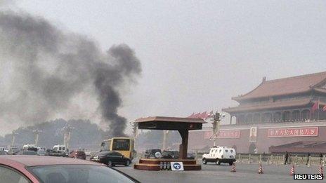 Vehicles travel along Chang'an Avenue as smoke rises at Tiananmen Square in Beijing, China, 28 October 2013