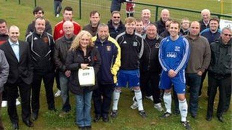 Paula Lunt presents the FA with their defibrillators