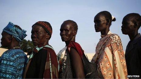 Women wait to vote in front of a polling station located at a school during a referendum in the town of Abyei on 27 October 2013