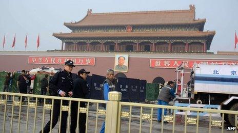 Policemen walk past barriers and fire vehicles outside Tiananmen Gate in Beijing on 28 October 2013