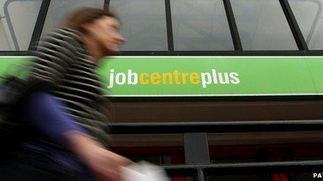 Woman walks past job centre