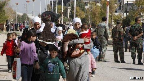 Syrian families leave their besieged town