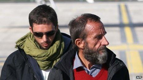 Former French hostages Pierre Legrand (left) and Daniel Larribe listen to the speech of French President Hollande