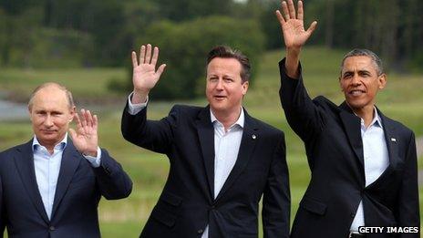 Vladimir Putin, David Cameron and Barack Obama wave to the camera