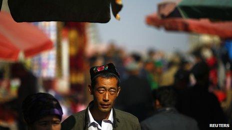 An ethnic Uighur man walks along a market in downtown Turpan, Xinjiang province 31 October 2013