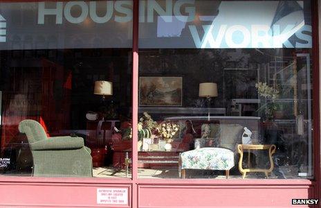 The banality of the banality of evil by Banksy on display in shop window