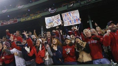 Fans celebrate at Fenway Park on in Boston, Massachusetts, on 30 October 2013