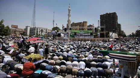 Thousands of Morsi supporters kneel during Friday prayers at the start of the sit-in at al-Rabaa al-Adawiya Mosque