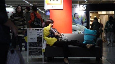 A woman sits on a sofa in Ikea