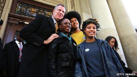 New York Democratic mayoral candidate Bill de Blasio poses with his family, wife Chirlane McCray, son Dante de Blasio and daughter Chiara de Blasio after voting at a New York public library branch on Election Day 5 November 2013