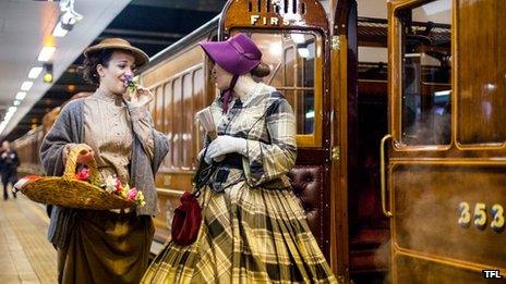 Women in heritage costumes next to the carriage