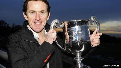 Tony McCoy poses with his trophy marking his 4,000th career victory at Towcester racecourse