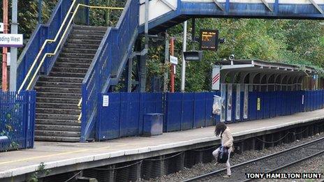 A woman crossing the track at Reading West Station