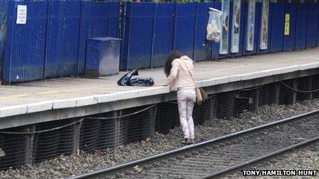 The woman preparing to get on the platform