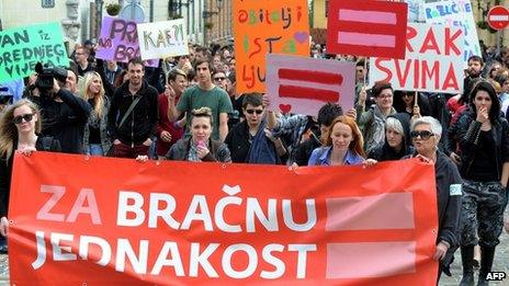 Gay rights activists march holding a banner calling for same-sex marriages in Zagreb in May