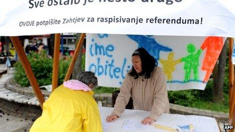 A Croatian woman signs a petition calling for a referendum to introduce a constitutional clause defining marriage as a union between a man and a woman.