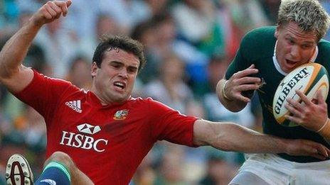 Jean de Villiers catches the ball under pressure from Jamie Roberts during the first test between South Africa and the Lions in 2009