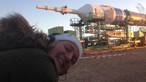 BBC camerawoman Rachel Price with Soyuz rocket in background