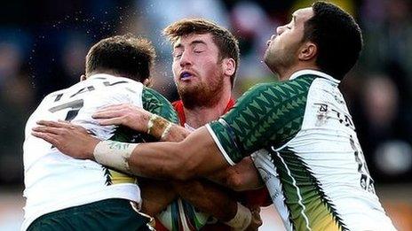 Wales' Rhys Evans is tackled by Isaac John and Tinirau Arona