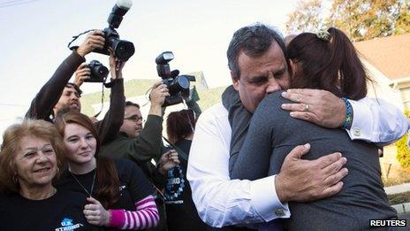 New Jersey Governor Chris Christie hugs a resident on the one-year anniversary of Hurricane Sandy in Union Beach, New Jersey October 29, 2013