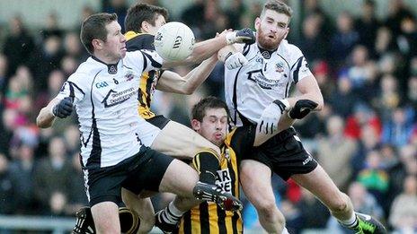 Kilcoo pair Paul Greenan and Sean O'Hanlon jump for the ball as Johnny Hanratty of Crossmaglen remains rooted to the ground