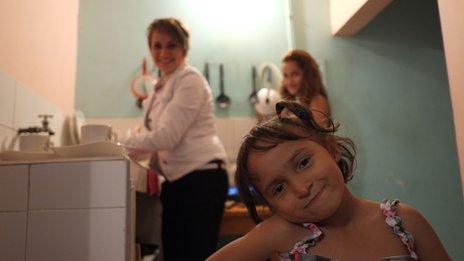 Yineth and her two daughters in her kitchen in Bogota