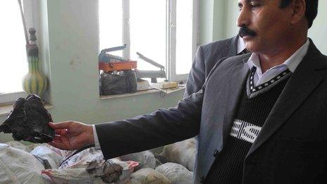 Colonel Fakhar Gul, head of Herat counter-narcotics police, with piece of raw opium in his hand