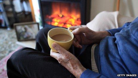 An old man sat by a fire