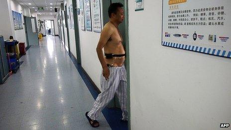 A man with diabetes walks into a ward at a diabetes hospital in Beijing (September 2013)