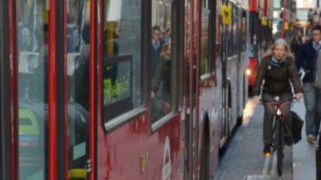 A cyclist and buses in Oxford Street