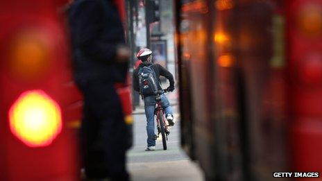 Cyclist between two buses in London