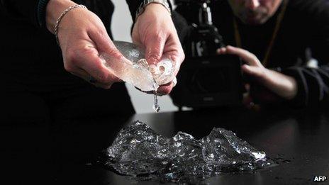 Virginia Moon, lawyer of Argentine women in the lawsuit for defective Poly Implant Prothese (PIP) French-made breast implants, shows one of them in her office at the district courts during a press conference