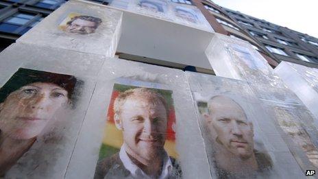 Portraits of Greenpeace activists are frozen in ice cubes in front of the headquarters of Gazprom Germany in Berlin