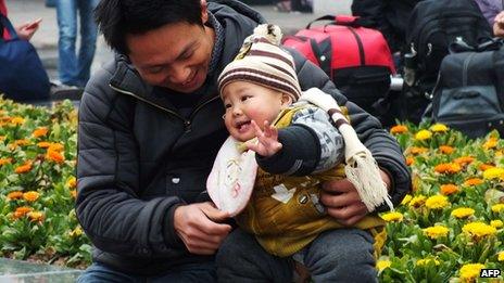 A Chinese man playing with his child at a park in Yichang, central China's Hubei province