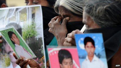 Sri Lankan Tamil mothers from the "Dead and Missing Persons' Parents" hold photgraphs during a protest in Jaffna, in northern Sri Lanka