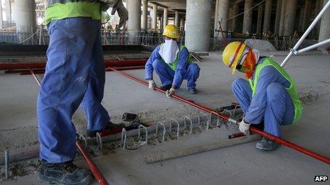 Migrant labourers work on a construction site in Doha in Qatar