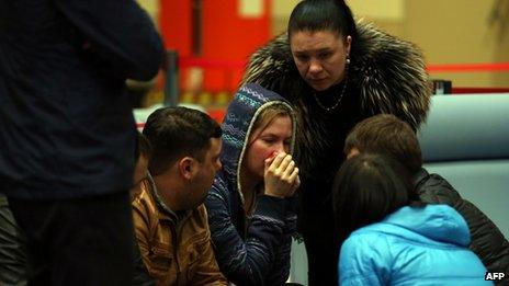 Relatives cry at Kazan airport. Photo: 17 November 2013