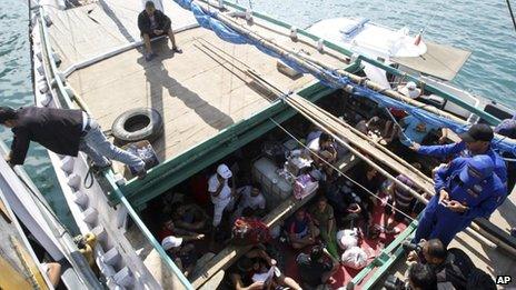 File photo: Iranian asylum seekers who were caught in Indonesian waters while sailing to Australia sit on a boat at Benoa port in Bali, Indonesia, 12 May 2013