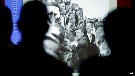 People watch a slideshow of President John F. Kennedy in Tampa, Florida on 18 November 2013