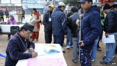 A Nepalese election official prepares ballots as voting begins at a polling station in Kathmandu on 19 November 2013